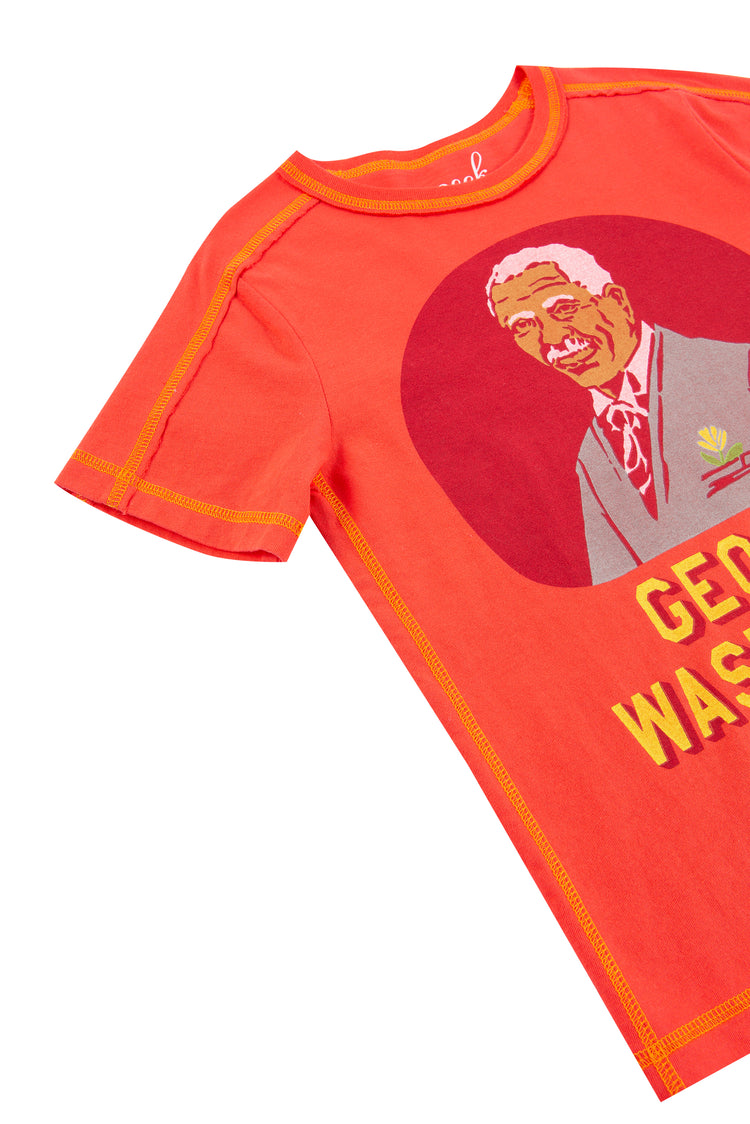 CLOSE UP OF ORANGE T-SHIRT WITH "GEORGE WASHINGTON CARVER"