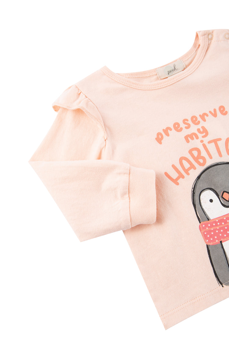 Close up view of pink and brown shirt with penguin image