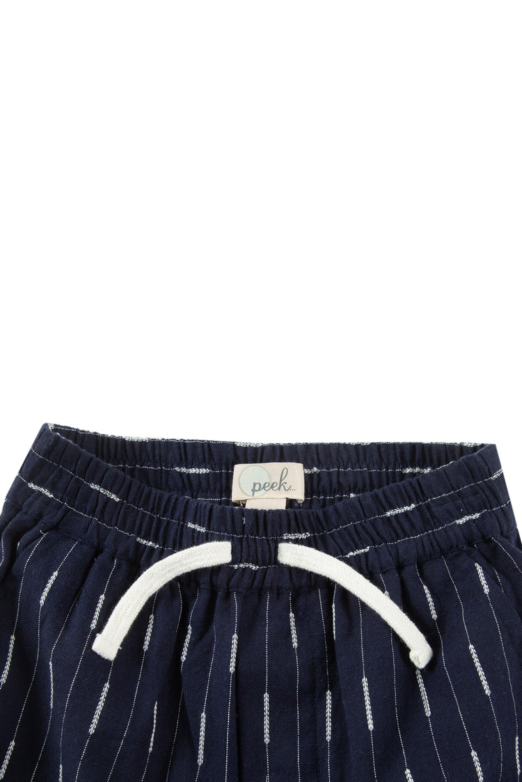 Close up of navy blue elastic waist pull on shorts with Faux drawstring.