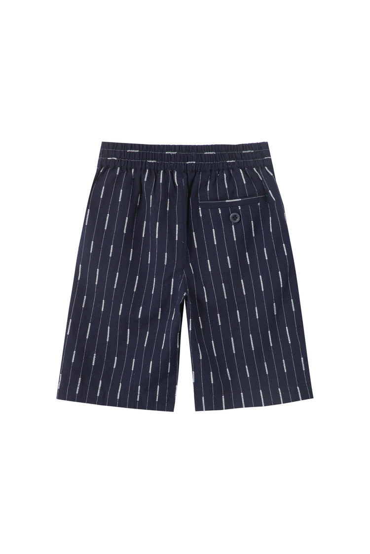 Back of navy blue elastic waist pull on shorts embroidered white stripes and one button pocket.