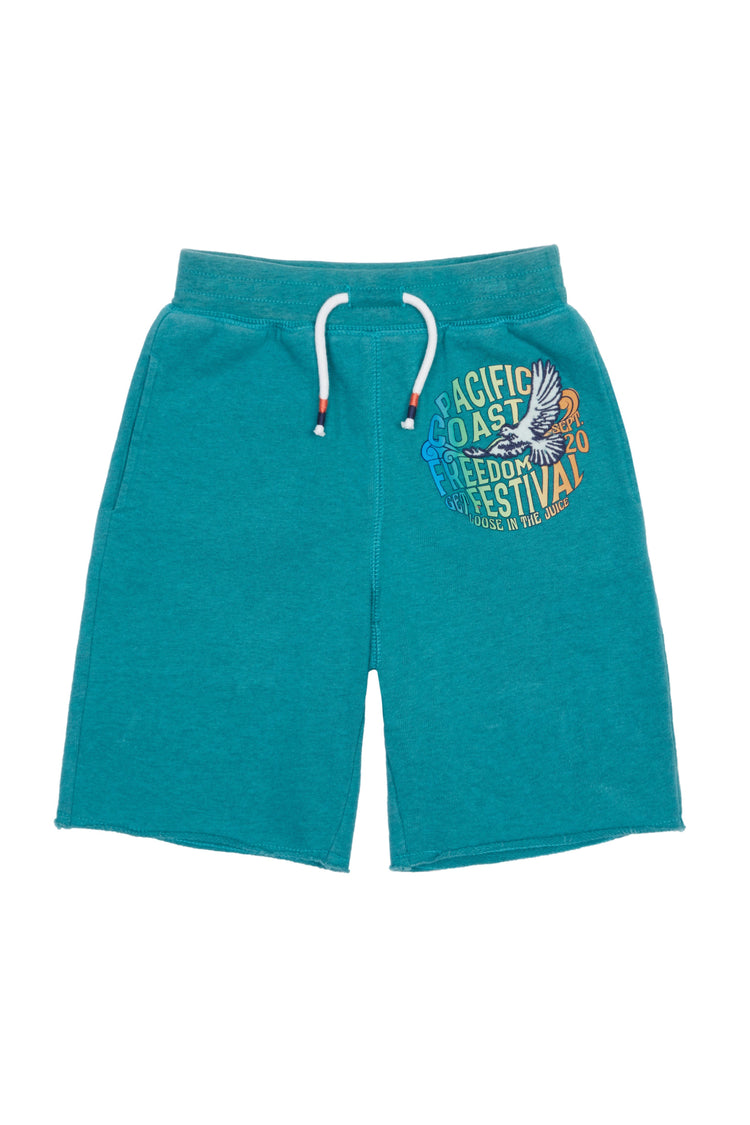 Teal-colored, elastic waist knit shorts with graphic of flying bird and words Pacific Coast Freedom Festival.