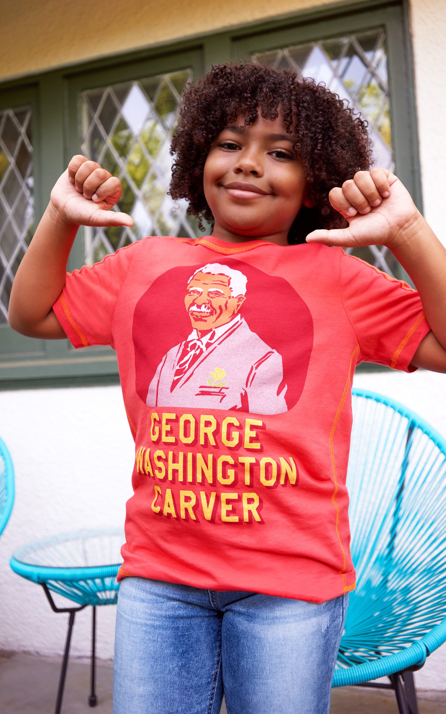 KID WEARING ORANGE T-SHIRT WITH "GEORGE WASHINGTON CARVER"
