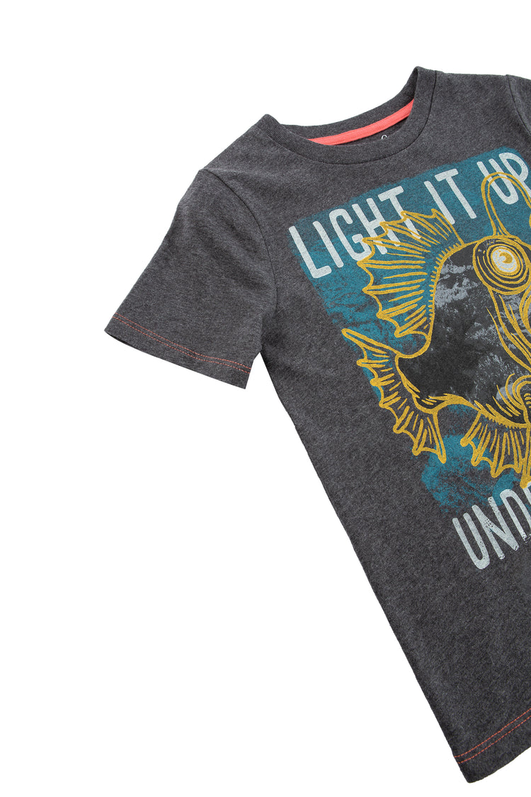 CLOSE UP OF DARK GREY T-SHIRT WITH FISH GRAPHIC AND THE WORDS "LIGHT IT UP UNDER THE SEA"