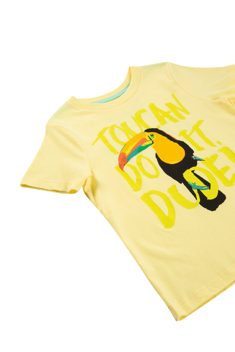 CLOSE UP OF YELLOW T-SHIRT WITH A TOUCAN AND "TOUCAN DO IT DUDE"