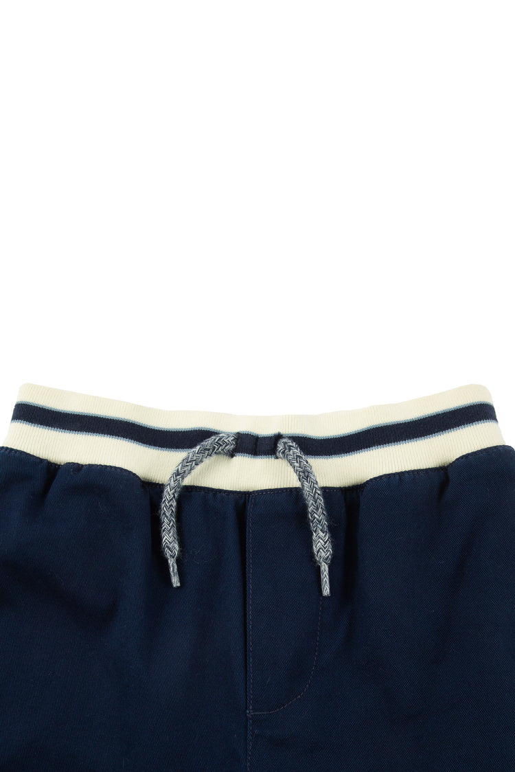 Close up of navy pull on shorts with white-and-blue striped waistband and gray drawstring