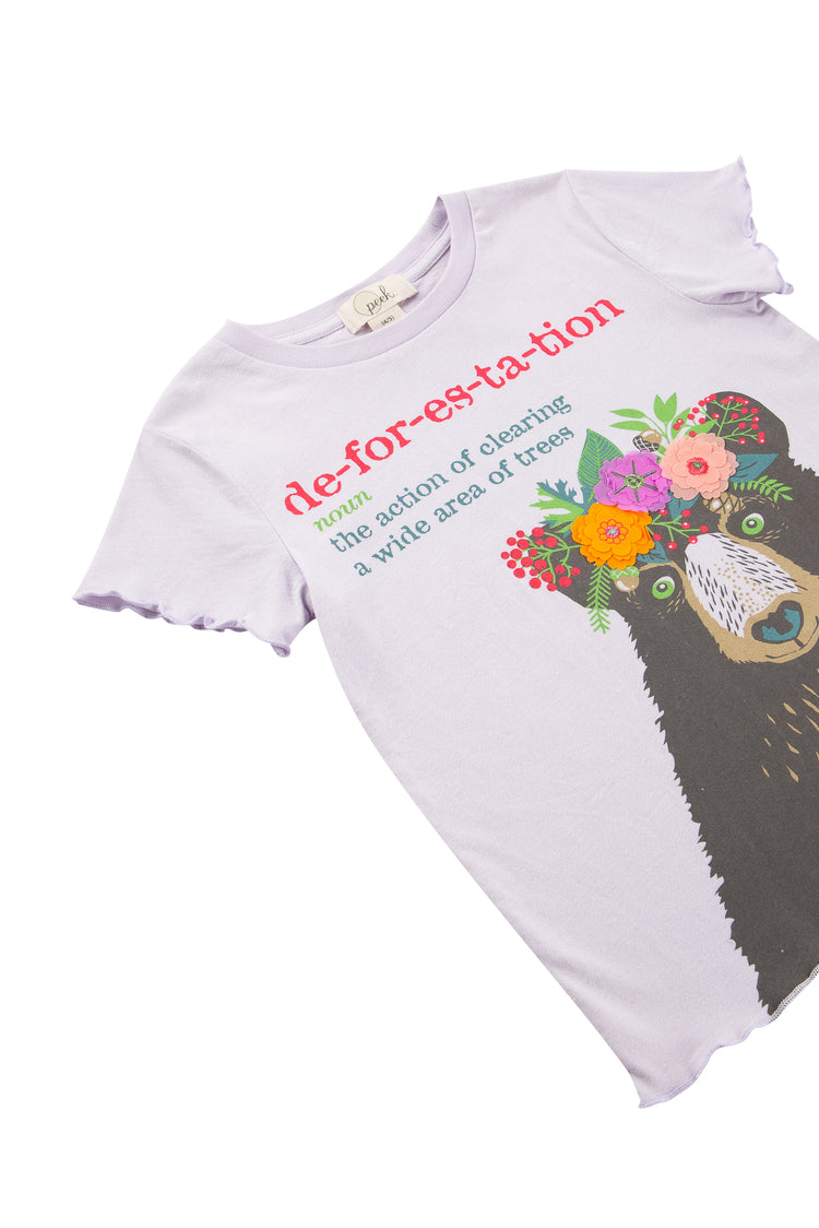 Close up of light purple t-shirt with illustrated bear wearing flowers and deforestation definition text