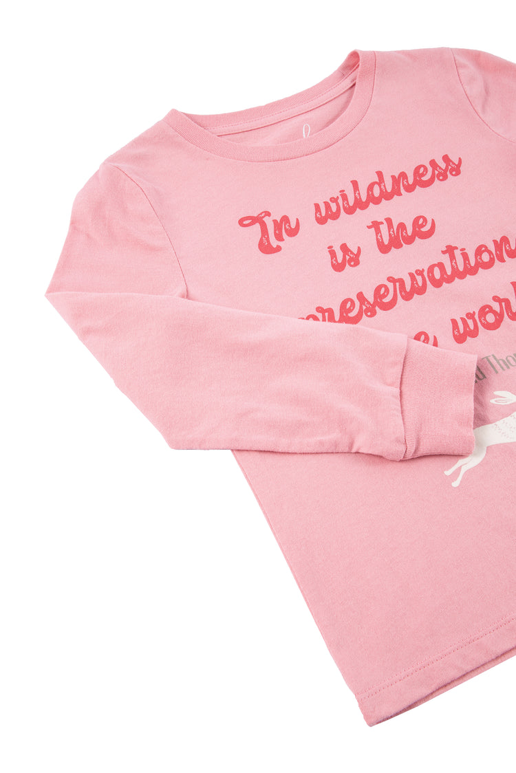 Close up of pink long-sleeve t-shirt with red text 'in wildness is the preservation of the world'