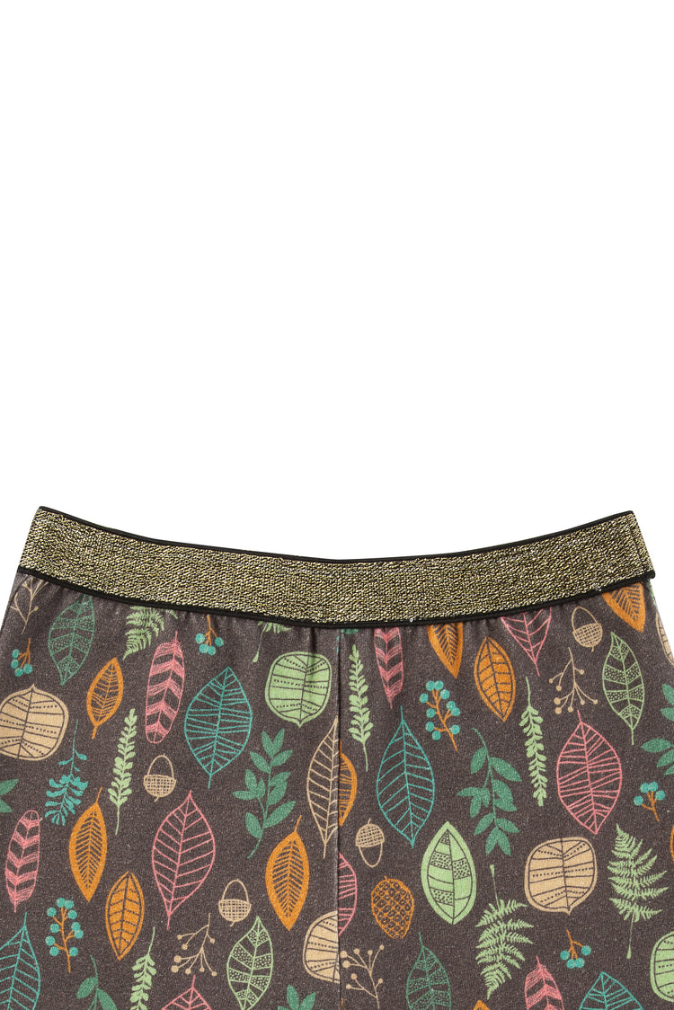 Close up of brown leggings with illustrated multi-colored foliage