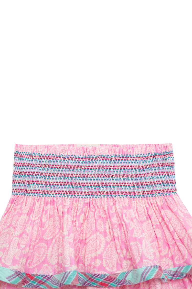 Close up view of tiered gauze skirt featuring mixed paisley and plaid patterns, as well as a smocked waist