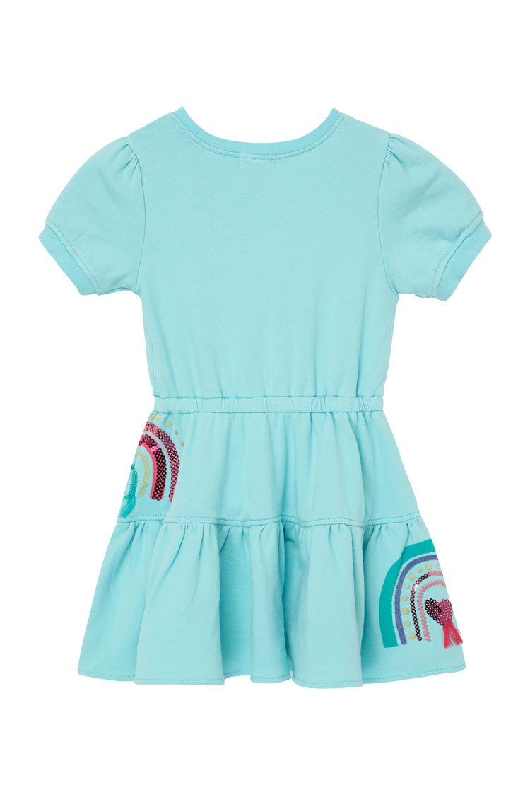 Back view of blue ruffle dress with rainbow pattern