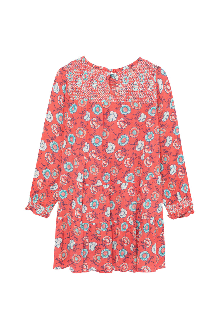 Back view of long sleeve dress featuring a smocked upper bodice and all-over floral print