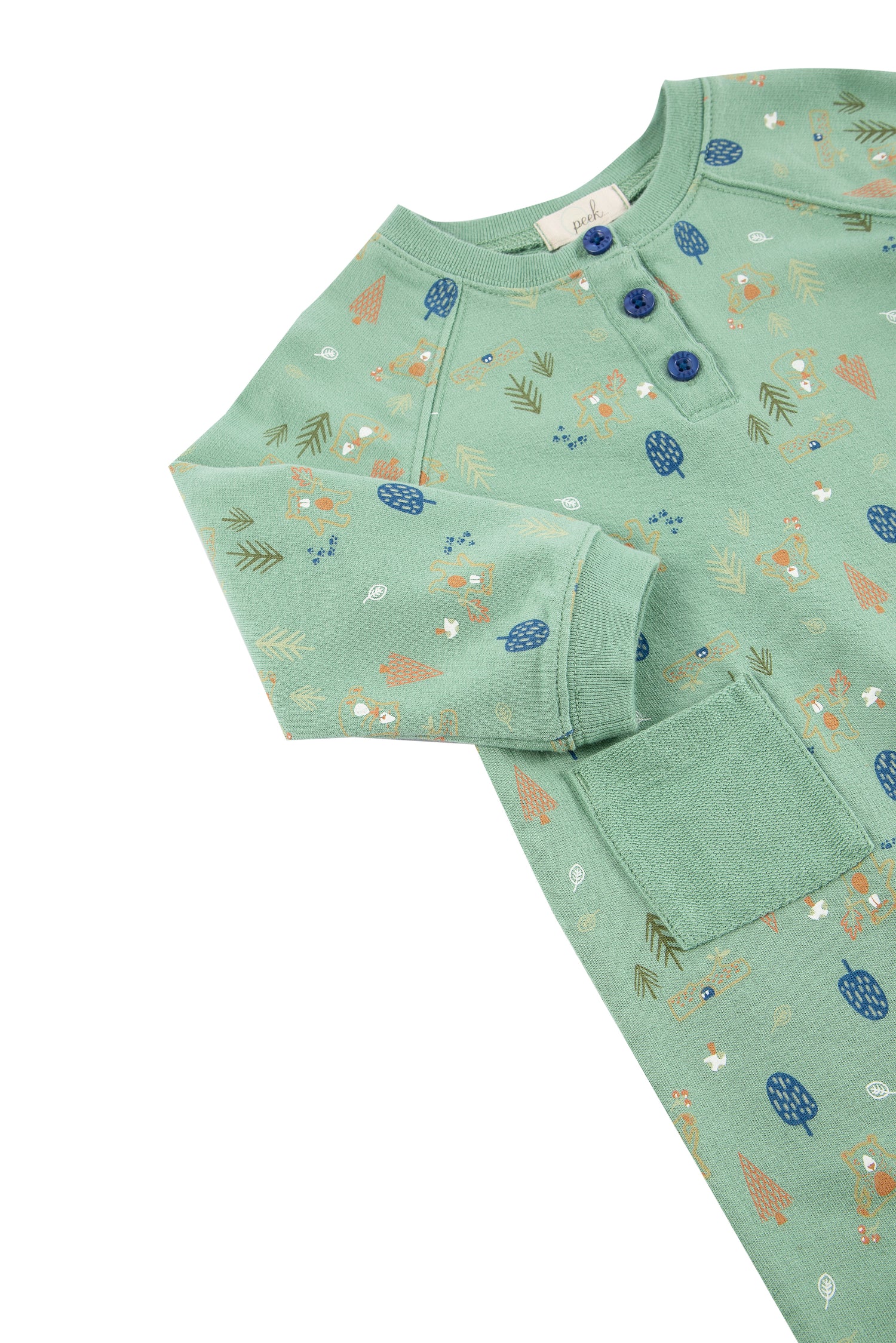 Close up side view of long sleeve coverall with woodland bears print, three top buttons, and front pockets