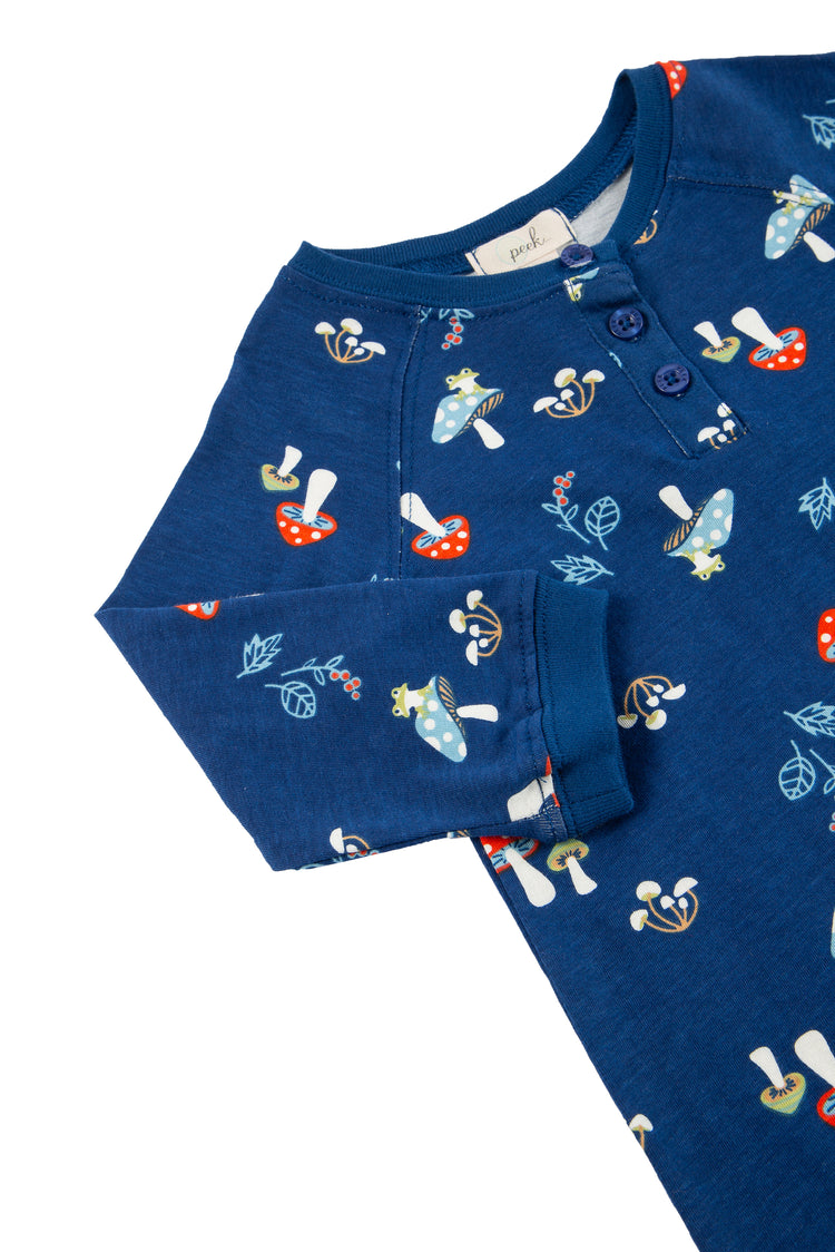 CLOSE UP OF DARK BLUE LONG-SLEEVE ONESIE COVERALL WITH MUSHROOM GRAPHICS