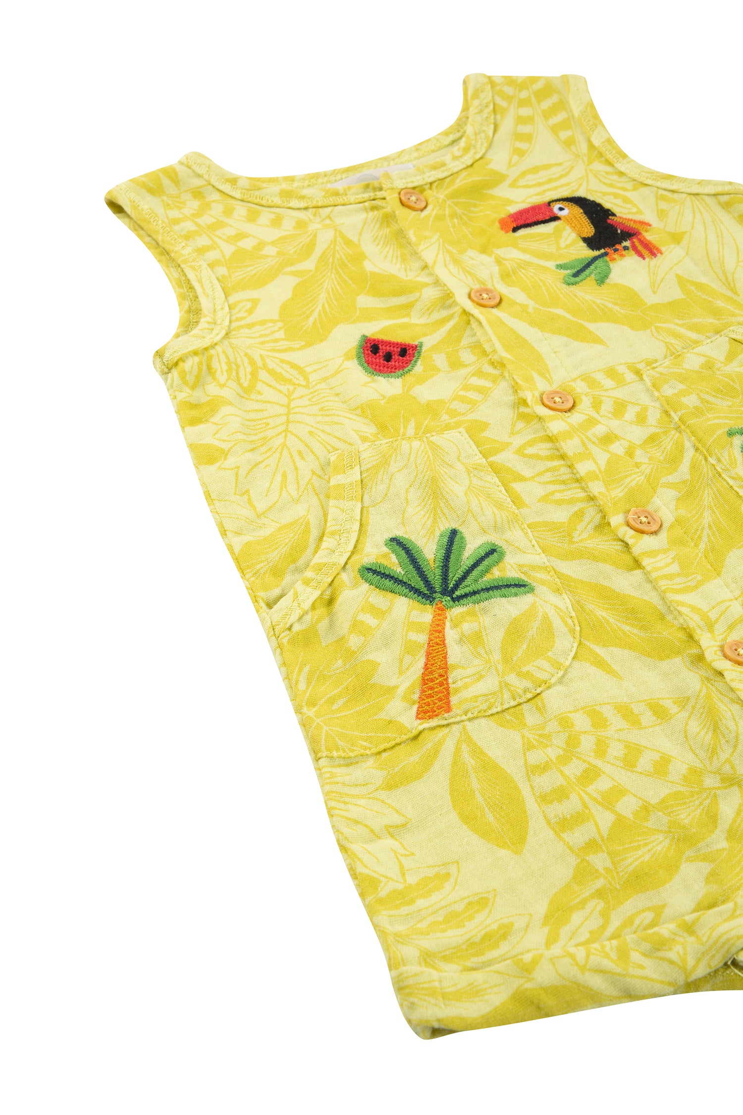 CLOSE UP OF YELLOW TROPICAL LEAF ROMPER WITH WATERMELON, TOUCAN AND PALM TREE EMBROIDERY