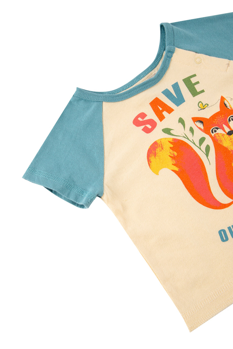 Close up of off-white and turquoise t-shirt with illustrated fox and "save our forest" text 