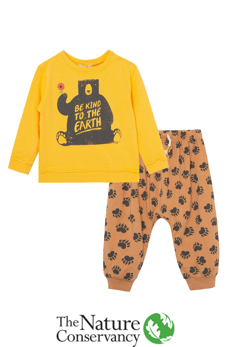 Yellow sweatshirt with illustrated bear holding a flower and 'be kind to the earth' text, with brown bear print pattern pants